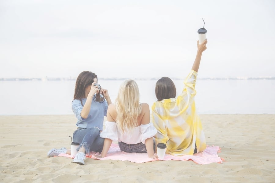 Three girls sitting on the beach