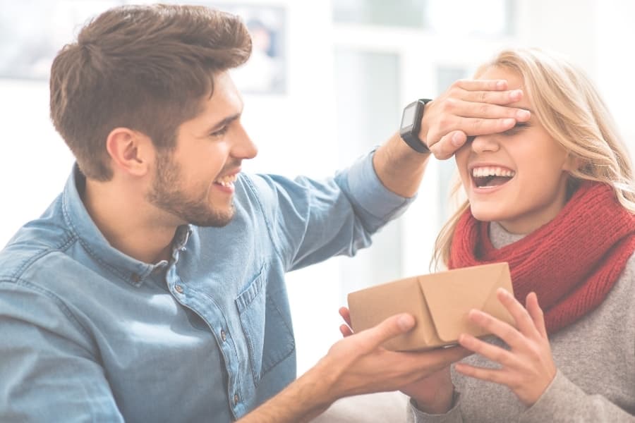 A college boyfriend giving his college girlfriend a Valentine's Day present.