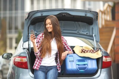 A girl who is packing her car for college move-in day.